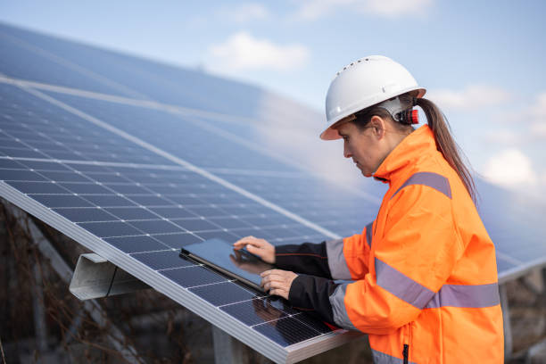 Female Engineer with Tablet in Solar Power Plant. Energy Saving Solutions.