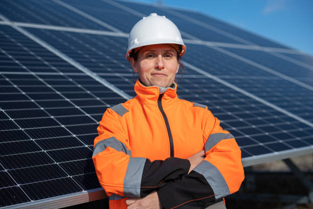 Female Engineer Portrait on Solar Panels Background. Solar City.