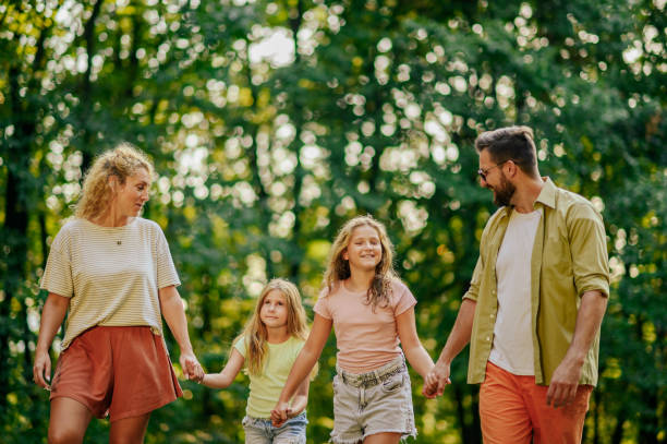 istock A loving family is talking a walk in forest. 2148210283