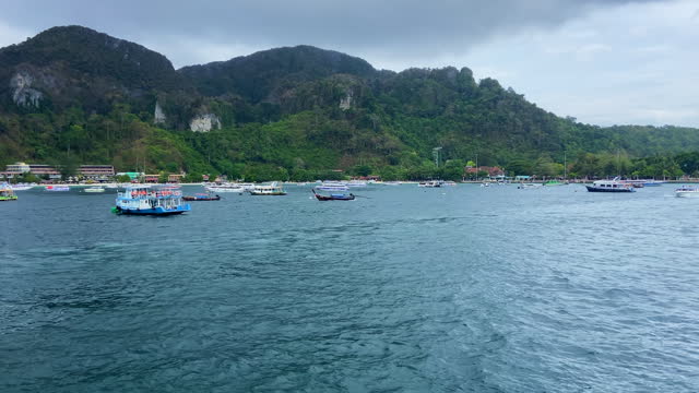 Many boats anchored in Phi Phi islands bay. Tourism in Thailand