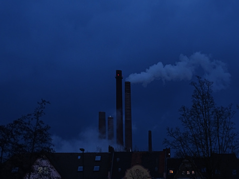 This photo was shot in early November 2023, in Dusseldorf, Germany at night fall, and it depicts a dark, heavily overcast and polluted sky.