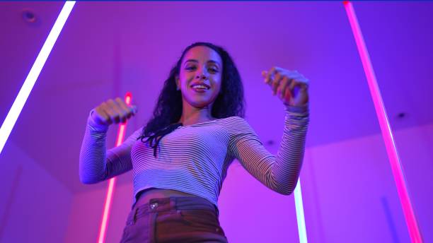 istock Low angle camera of hispanic dancer looking at camera and dancing. Regalement. 2148211757