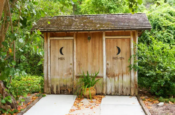 Wooden outdoor bathroom for men and women