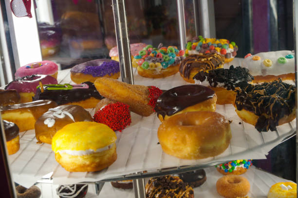 istock A rotating case of fancy, colorful donuts 2148211794
