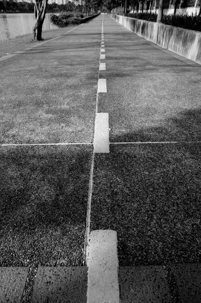 istock Long Jogging Lanes in a Park (in monochrome) 2148212133