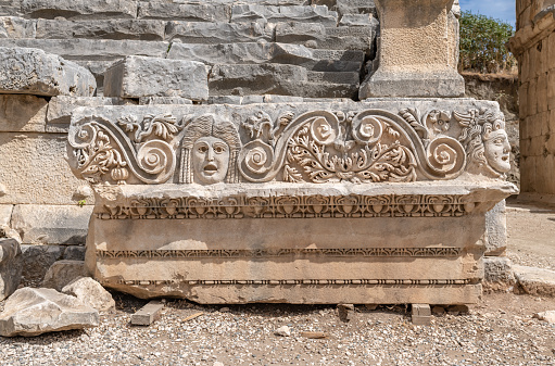 Stone masks at the ancient theatre of Myra in Demre, Antalya province of Turkey.