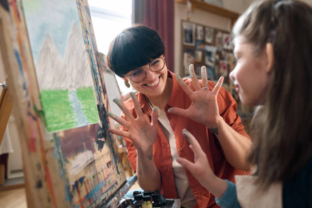 istock Playful Teacher Working with Children in Art Class 2148215032