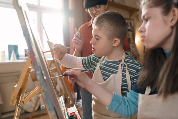 istock Children with Disability Painting Together 2148215052