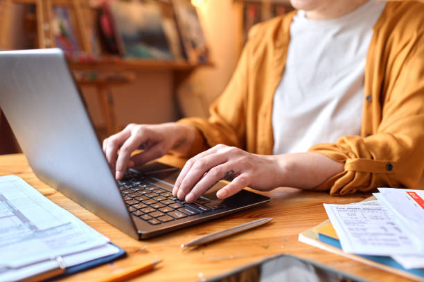 Woman typing on laptop keyboard Close up of woman typing on laptop keyboard while managing small business, copy space types of loans stock pictures, royalty-free photos & images