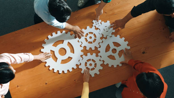istock Top view of business people gathering white gear together at table. Convocation. 2148217190