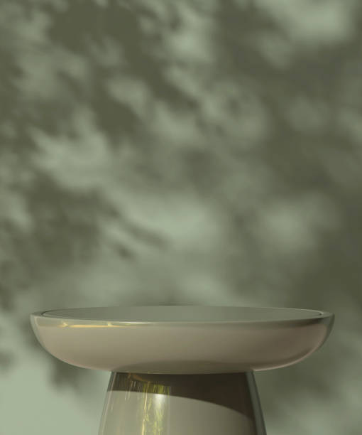 istock Empty green round stone table podium in dappled sunlight, leaf foliage shadow on green concrete wall 2148217349