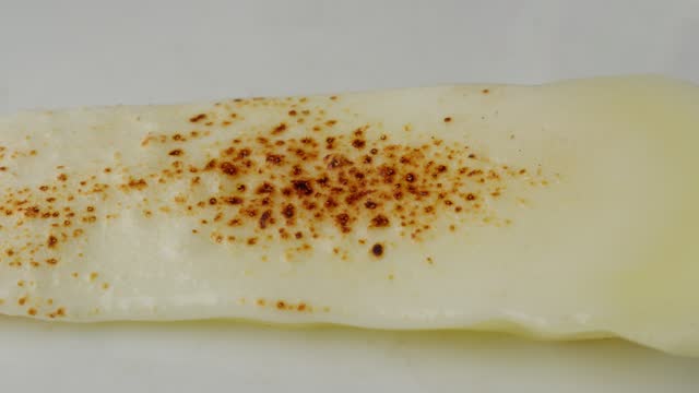 Melting And Burning Mozzarella Cheese On Bread With Fire From Blow Torch. macro, timelapse
