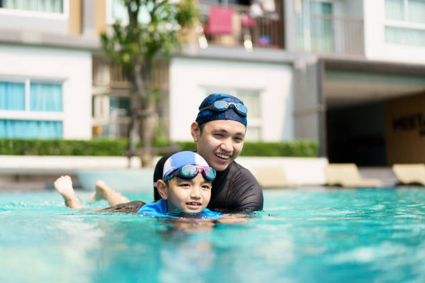 istock Little boy and father enjoy swimming. 2148218135