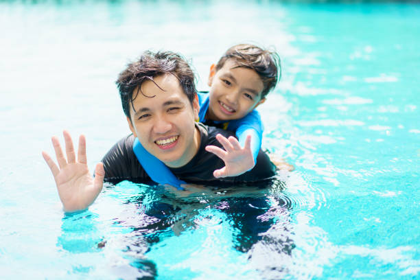 istock Little boy and father enjoy swimming. 2148218136