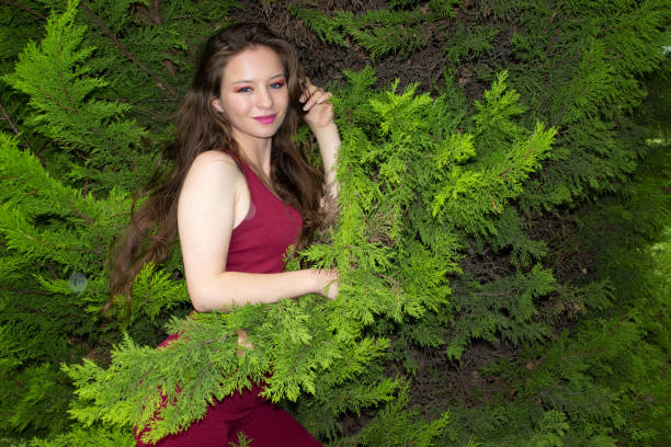 Beautiful young woman posing in a public park
