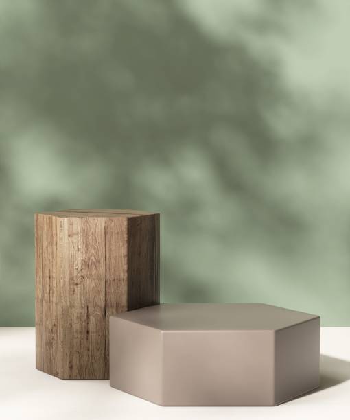 istock Two brown hexagon podium table podium in dappled sunlight, leaf foliage shadow on green wall, white floor 2148218444