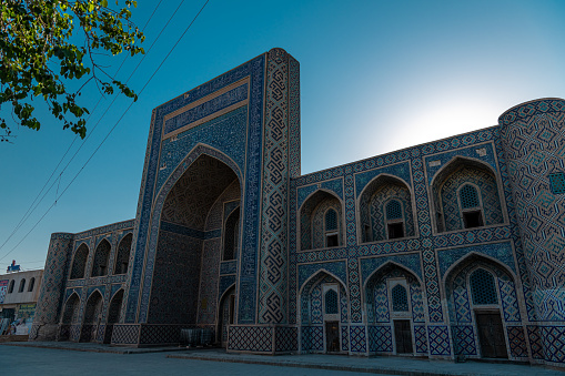 JUNE 27, 2023, BUKHARA, UZBEKISTAN: View of the dome and tower of Poi Kalon Mosque at the sunset, in Bukhara, Uzbekistan. Horizontal image with copy space for text