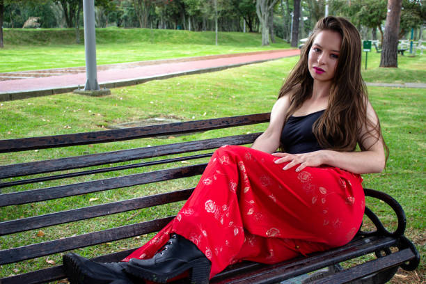 Beautiful young woman posing in a public park
