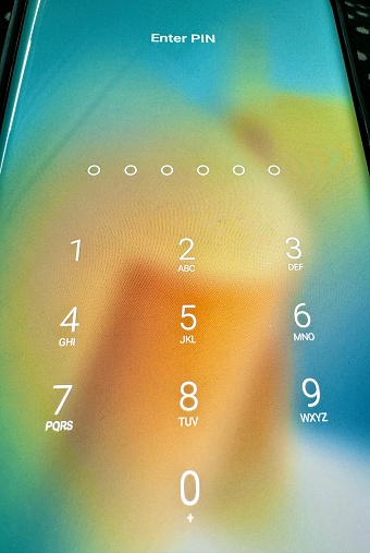 Macro shot of a mobile screen asking for passcode to unlock the phone.