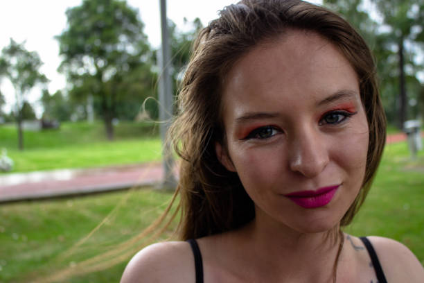 istock Beautiful young woman posing in a public park 2148218937