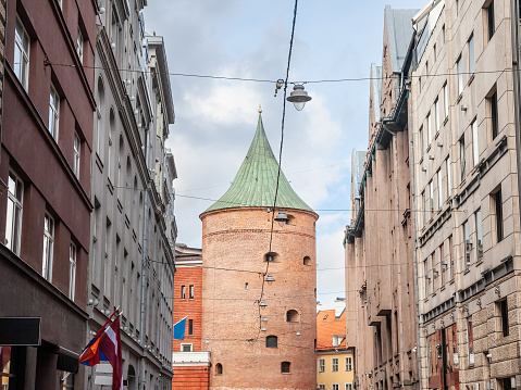Panorama of a street of the old rica (vecriga) in latvia with a focus on the Riga powder tower, also called pulvertornis. It's a major landmark of the ancient riga.
