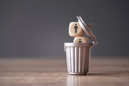 Relationship, remove toxic people concept. Wooden cube with people icon inside dustbin, trash can.