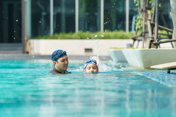 istock Little boy and father enjoy swimming. 2148221769