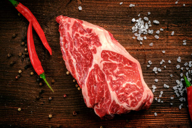 istock Raw Chuck Eye Roll beef Steak on a rustic wooden background with seasonings 2148222283