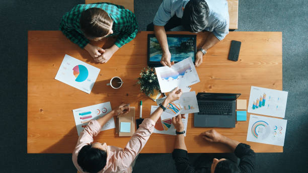 istock Top view of business people hand working together to analyze chart. Convocation. 2148222579