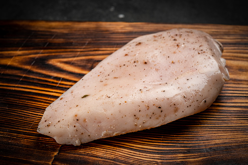 Fresh sous vide chicken breast prepared for grilling with seasonings