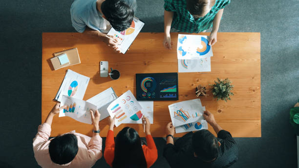 istock Top down view of business people analyze data together at meeting. Convocation. 2148222709