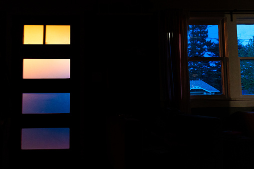 4 glass panes with back lit colorful light coming through in a high contrast light abstract color blend image.