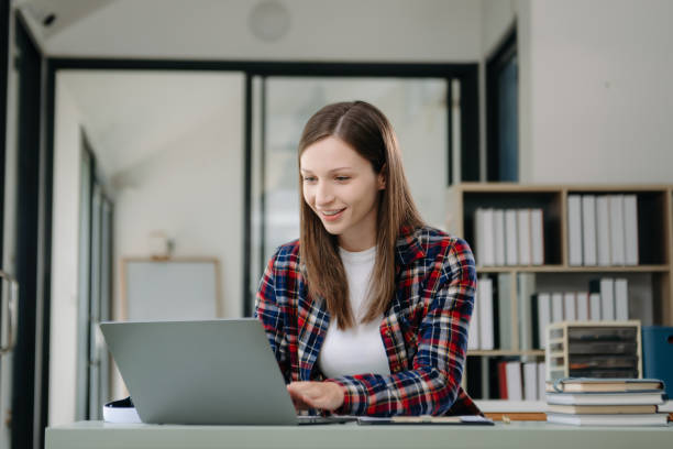 istock Confident woman with a smile standing holding notepad and tablet at the office. 2148223062