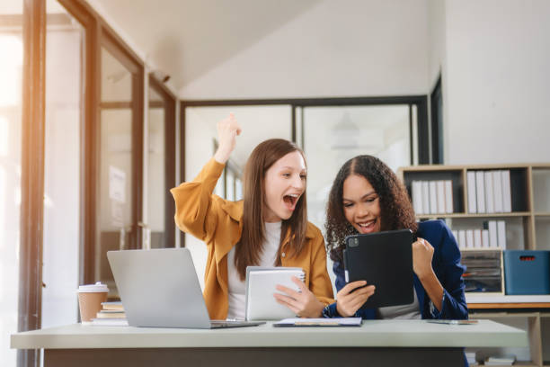 istock Business colleague business presents and explains and using laptop and tablet. Teamwork, financial marketing team 2148223093