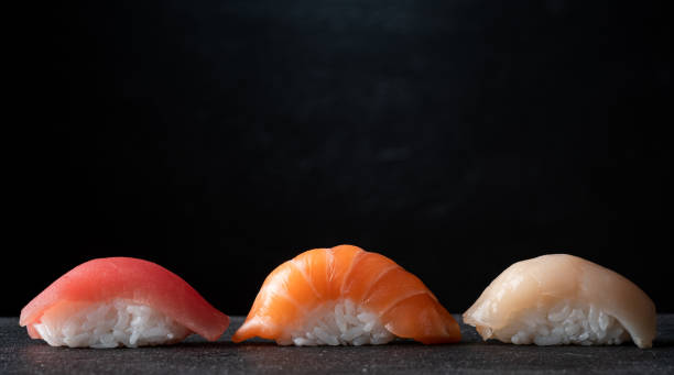 istock Sushi set on a black stone background, Japanese cuisine 2148223645