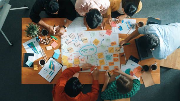 istock Group of business people writing and making mind map at meeting. Convocation. 2148224302