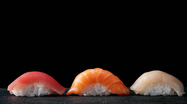 istock Fresh fish sushi set on a black stone background, Japanese national dish 2148224358