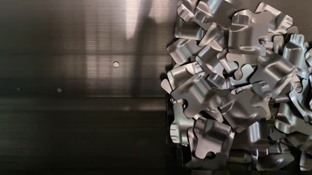 An industrial conveyor belt with metal scrap in a metal processing company.