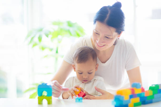 istock Baby boy  and mother playing with toy 2148227859