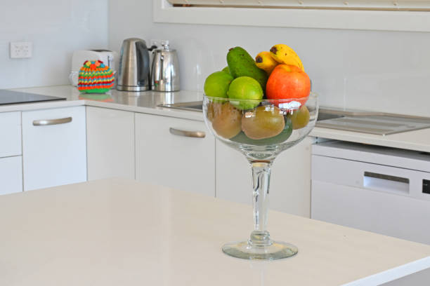 Giant wine glass in the kitchen being used as a fruit bowl