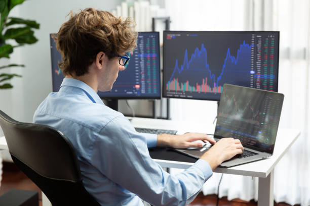 istock Working business trader typing and focusing on laptop on market data. Gusher. 2148229785