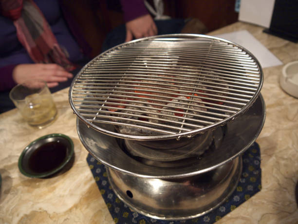 A woman eating at a Japanese yakiniku restaurant