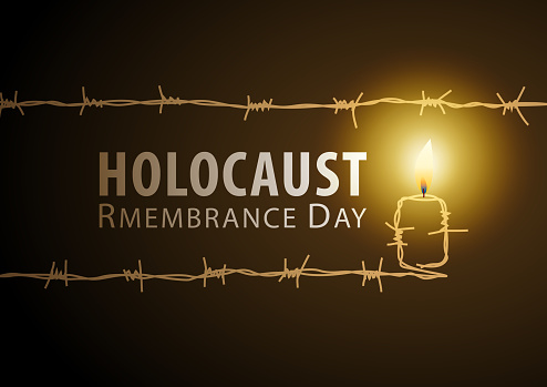 Remembering the holocaust tragedy of Jews for the Holocaust Remembrance Day that occurred during the Second World War igniting the candle made from barded wire