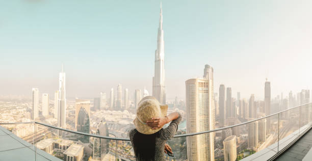 istock Dubai, UAE - 12th october, 2022: Burj Khalifa View from sky view downtown, lady by infinity pool looking at the tallest building in the world. Visit Dubai sky view hotel on holiday 2148230105