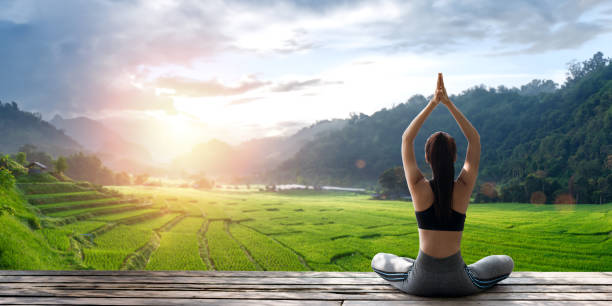istock Young woman practicing yoga in the nature 2148230126