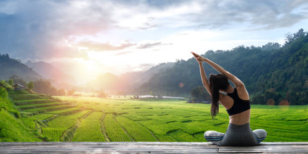 istock Young woman practicing yoga in the nature 2148230135