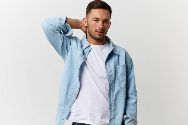 istock Pensive serious tanned handsome man in casual basic t-shirt touch neck posing isolated on over white studio background. Copy space Banner Mockup. Lifestyle People emotions concept 2148230783