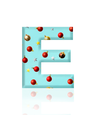 Close-up of three-dimensional Christmas ornament alphabet letter E on white background.