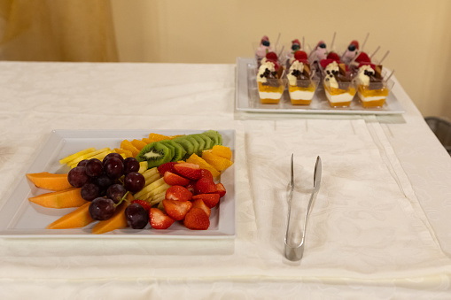 an array of colorful fresh fruits alongside decadent desserts ready to delight guests at a festive banquet