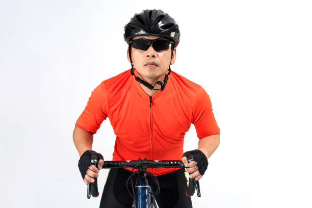 Cyclist with helmet and sunglasses riding a bicycle isolated on white background